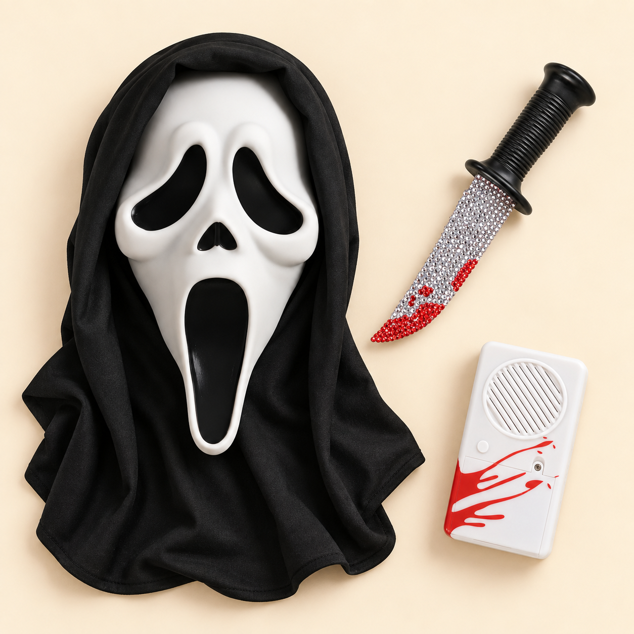 White Ghost Face mask with black hood, rhinestone costume knife, and white voice changer with red accents on a cream background.